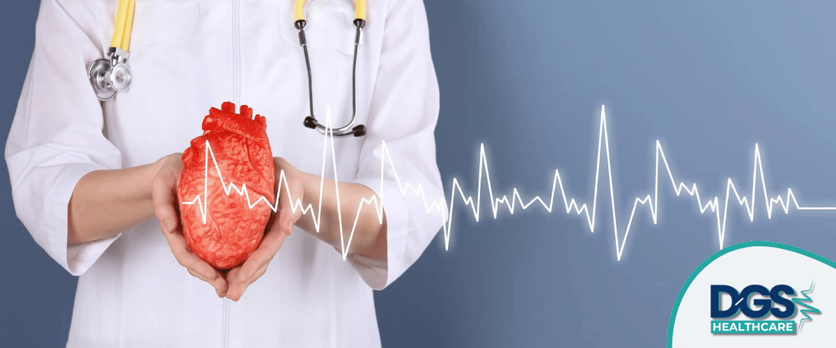 Doctor holding heart model with ECG Cardiology Treatment in Turkey